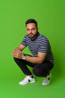 © Ranta Images - Young bearded Indian man against green background