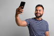 © Ranta Images - Young bearded Indian man against white background