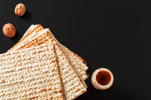 A Photo Of Matzah Or Matza Pieces  On Black Background. Matzah For The Jewish Passover Holidays. Place For Text, Copy Space