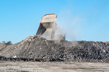 Wall Mural - Mining truck dumping tailings onto stockpile