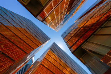 Poster - golden building with blue sky. windows glass of modern office skyscrapers. facade design. architectu