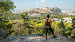 Woman standing on Philopapos Hill looking at Acropolis