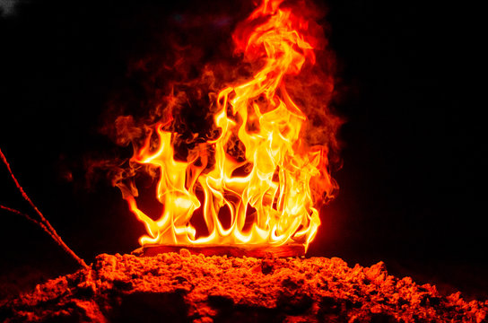 Wooden figures 2018 are burned in a flame. Conceptual photo end of the year.