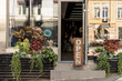 © LIGHTFIELD STUDIOS - open signboard, potted plants and reflecting windows at flower shop