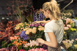 © LIGHTFIELD STUDIOS - back view of florist taking care of bouquets in flower shop