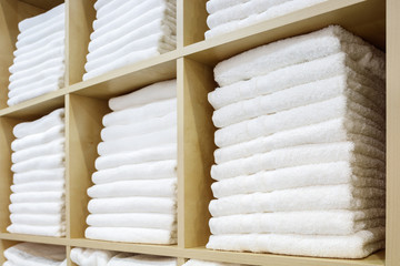 Poster - White Towels Folded and Stacked on a Shelf