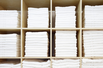 Leinwandbilder - White Towels Folded and Stacked on a Shelf