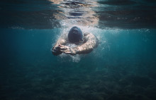 Underwater View Of Man Swimming In The Sea