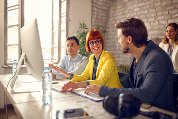 Wall Mural - Photographer in studio show photos to business colleagues