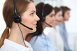 © rogerphoto - Call center. Beautiful cheerful smiling operator consulting clients with headset. Business concept of customer service