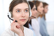 © rogerphoto - Call center. Beautiful cheerful smiling operator consulting clients with headset. Business concept of customer service