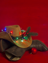 Cowboy Christmas.American West Traditional Boots On Christmas Red Background