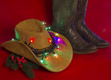 Cowboy Christmas.American West Traditional Boots On Christmas Red Background