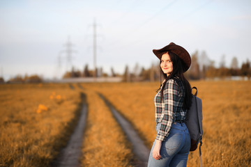 A young girl is traveling around the city hitchhiking. A beautif