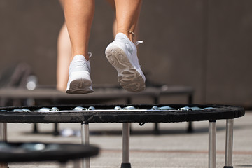 Fitness women jumping on small trampolines,exercise on rebounder