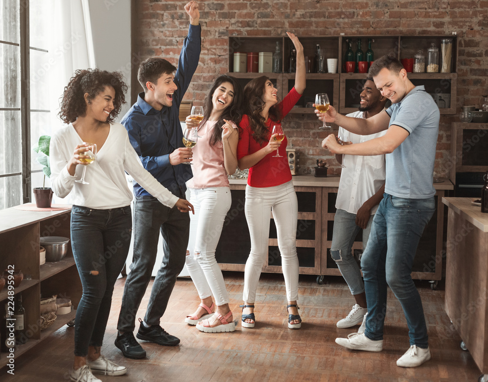Multiracial friends dancing and drinking at birthday party - obrazy, fototapety, plakaty 