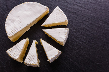 delicious creamy camembert cheese on a wooden rustic background