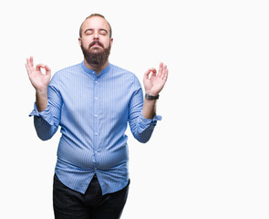 Sticker - Young caucasian hipster man over isolated background relax and smiling with eyes closed doing meditation gesture with fingers. Yoga concept.