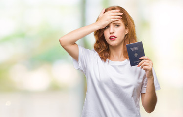 Canvas Print - Young beautiful woman holding passport of germany over isolated background stressed with hand on head, shocked with shame and surprise face, angry and frustrated. Fear and upset for mistake.