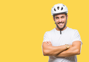 Young handsome man wearing cyclist safety helmet over isolated background happy face smiling with crossed arms looking at the camera. Positive person.