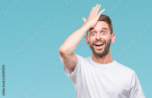 Fotografía Young handsome man over isolated background surprised with hand on head for mistake, remember error