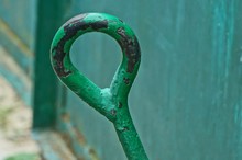 Steel Handle Of An Old Green Tool On The Street
