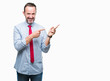 © Krakenimages.com - Middle age hoary senior business man wearing red tie over isolated background smiling and looking at the camera pointing with two hands and fingers to the side.