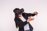 Fototapeta Młodzieżowe - Technology and people concept - Amazed young woman touching the air during the VR experience