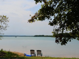 Two beach chairs set out looking over Lake Murray at the Lake Murray State Park, the largest state park in in the Oklahoma. 