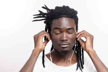 Portrait of a happy african american male listening to music with headphones