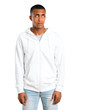 © luismolinero - Dark-skinned young man with white sweatshirt is a little bit nervous and scared pressing the teeth on isolated white background