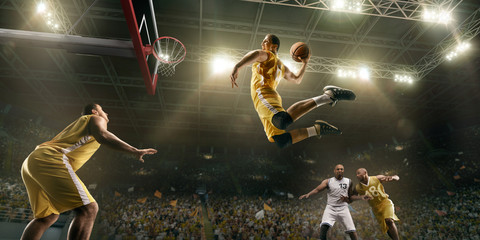 basketball players on big professional arena during the game. basketball player makes slum dunk. bot
