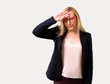 © luismolinero - Middle-age blonde business woman with black jacket with tired and sick expression on isolated grey background