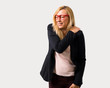 © luismolinero - Middle-age blonde business woman with black jacket suffering from pain in shoulder for having made an effort on isolated grey background