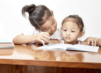 Two little girls thai homework