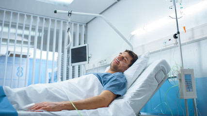 Wall Mural - Sick Male Patient Lying on a Bed in the Private Ward in Hospital. White, Clean Environment.