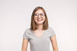 Young beautiful funny woman in glasses over white background