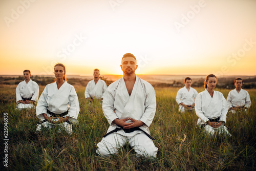Εκτύπωση καμβά Karate group sitting on the ground and meditates