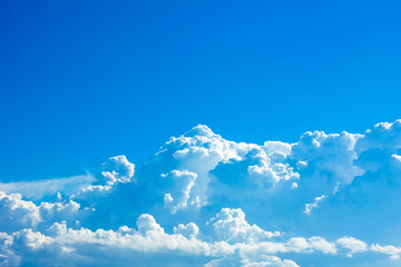 Blue sky background with white clouds.
