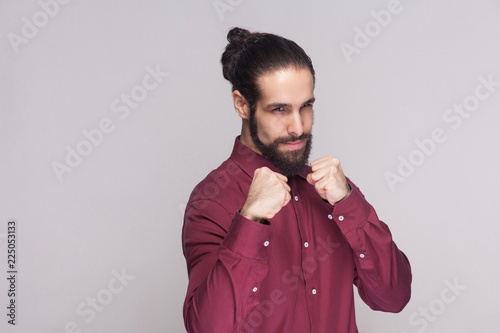 Portrait Of Serious Handsome Man With Dark Collected Long Hair And