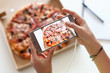 © Ilike - Young girl hands taking a picture of her meal - a box of pizza