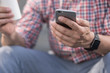 © shevchukandrey - Close up of a smartphone in hands of a pleasant man