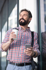 Wall Mural - Waist up of a positive man drinking coffee