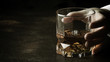 Whiskey glass in hand on the dark bar counter, selective focus