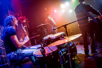 Wall Mural - Drummer playing on drum set on stage.