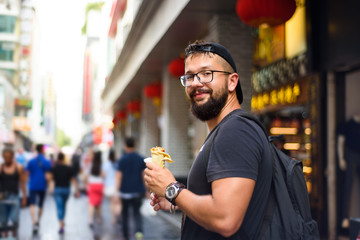 Foreigner eating Chinese street food