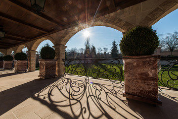 Wall Mural - Wrought iron fence on balcony, shadows of sun