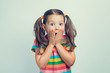 © Myst - shocked or surprised beautiful cute little girl closing her mouth with hands