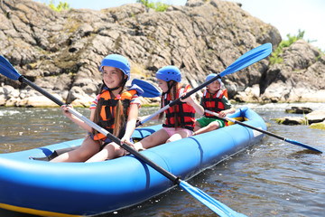 Wall Mural - little children kayaking on river. summer camp