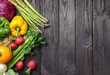 Flat lay composition with assortment of fresh vegetables on wooden table. Space for text